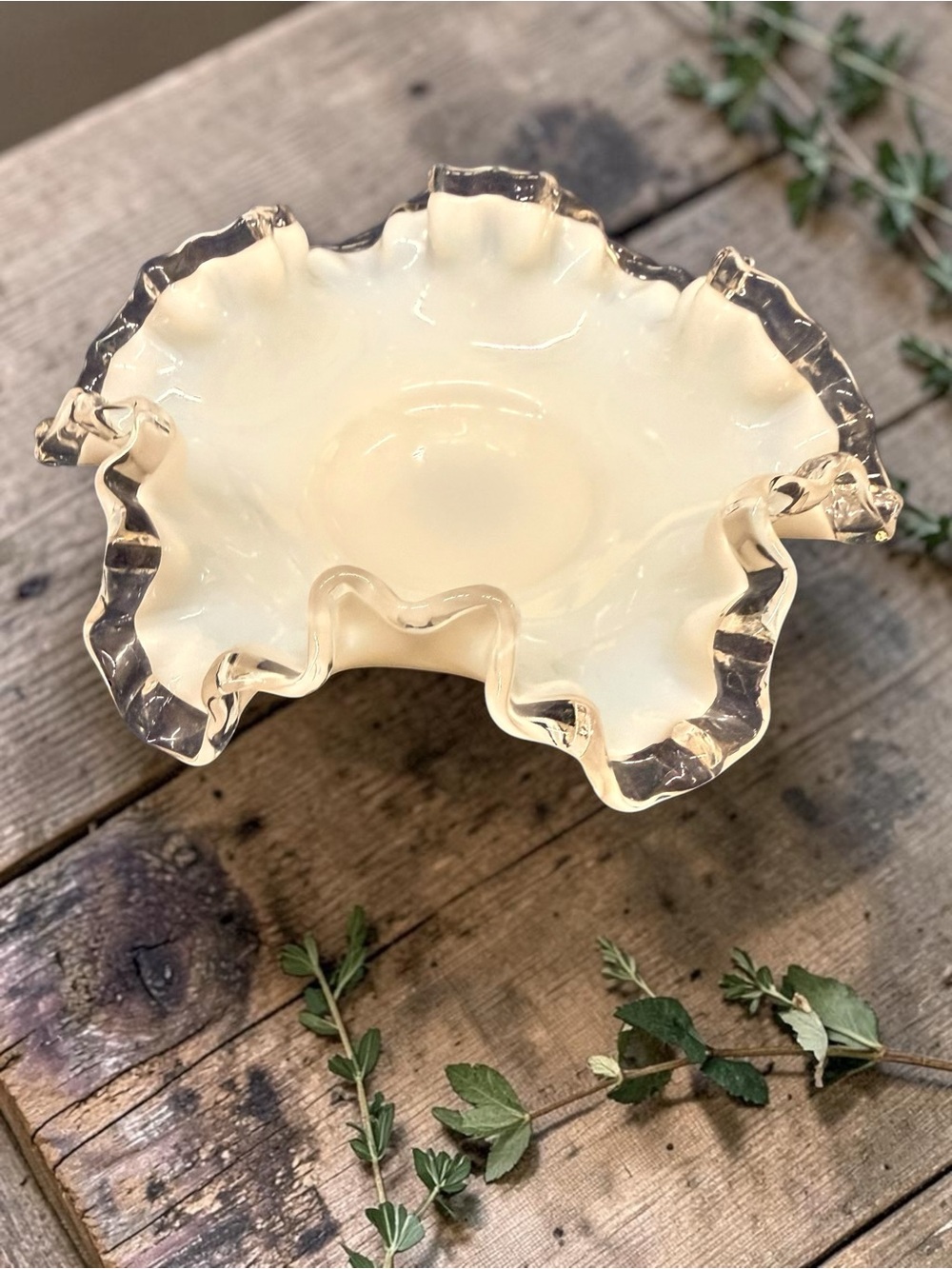 A Fenton Silver Crest milk glass bon bon dish with a ruffled edge.